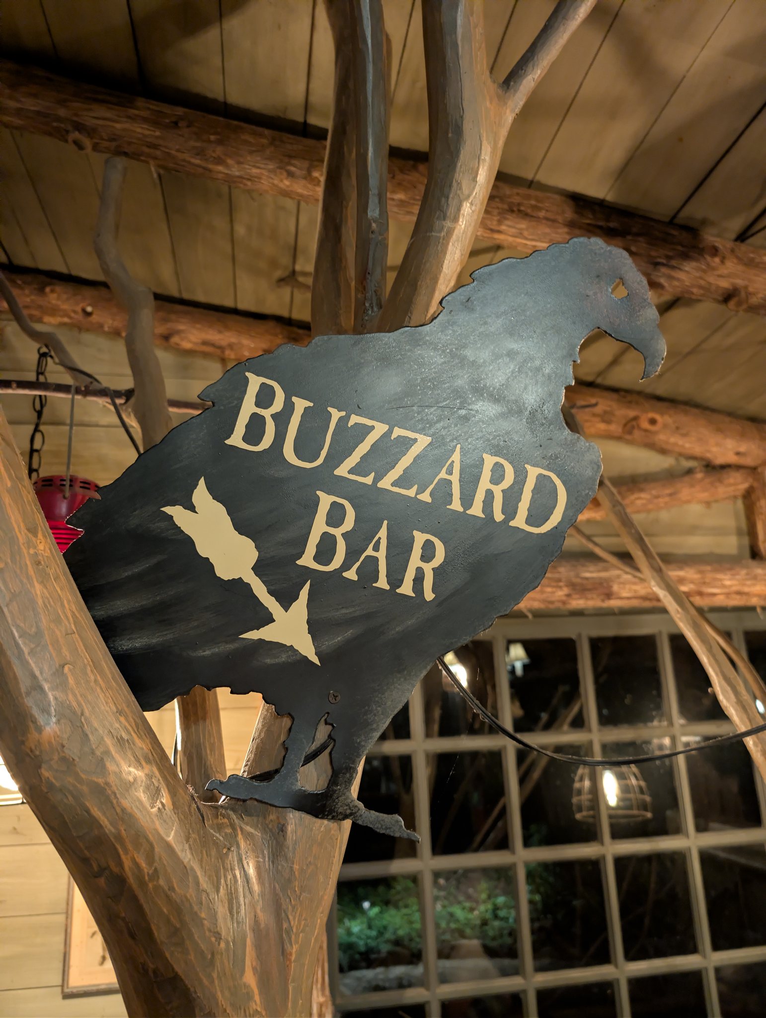 Buzzard Bar metal bird sign inside the rustic bar at Big Cedar Lodge near Branson, Missouri