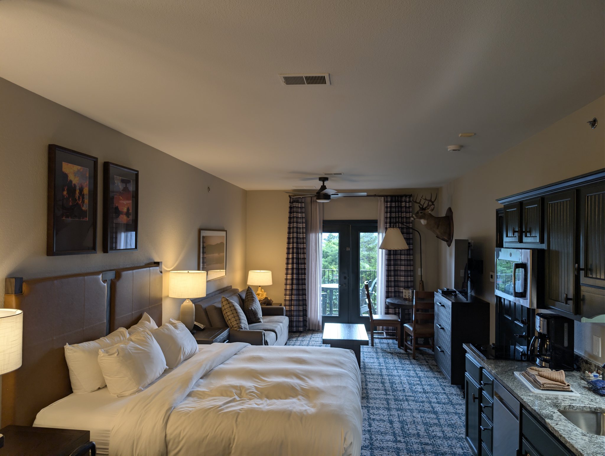 King suite with kitchenette, living area, and balcony at Bluegreen Wilderness Club at Big Cedar near Branson, Missouri