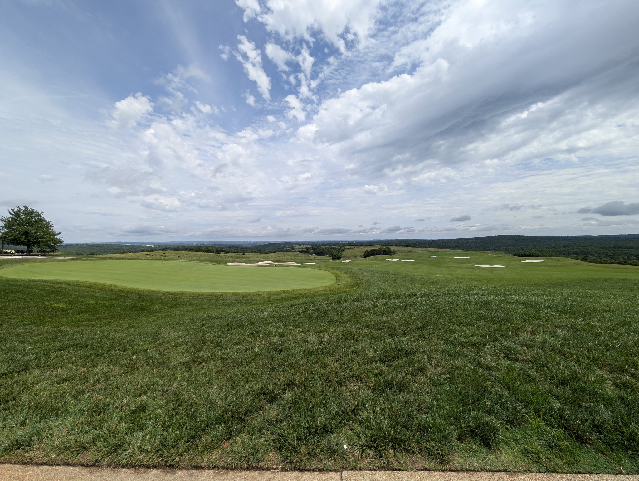 Expansive Buffalo Ridge golf practice range and short-game greens under cloudy Ozarks skies near Branson, Missouri