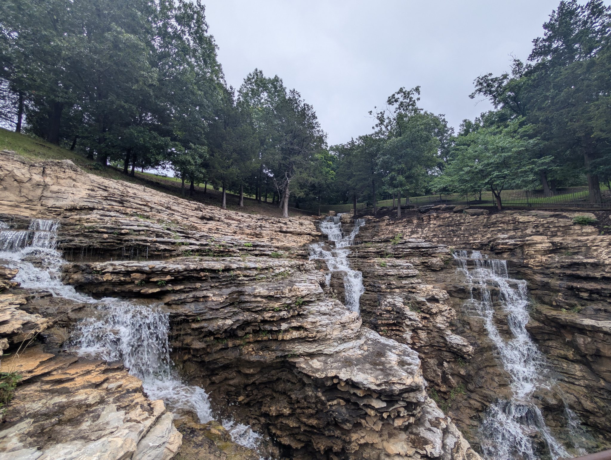 Multi-tiered waterfall over layered rock at Top of the Rock canyon trails near Branson, Missouri