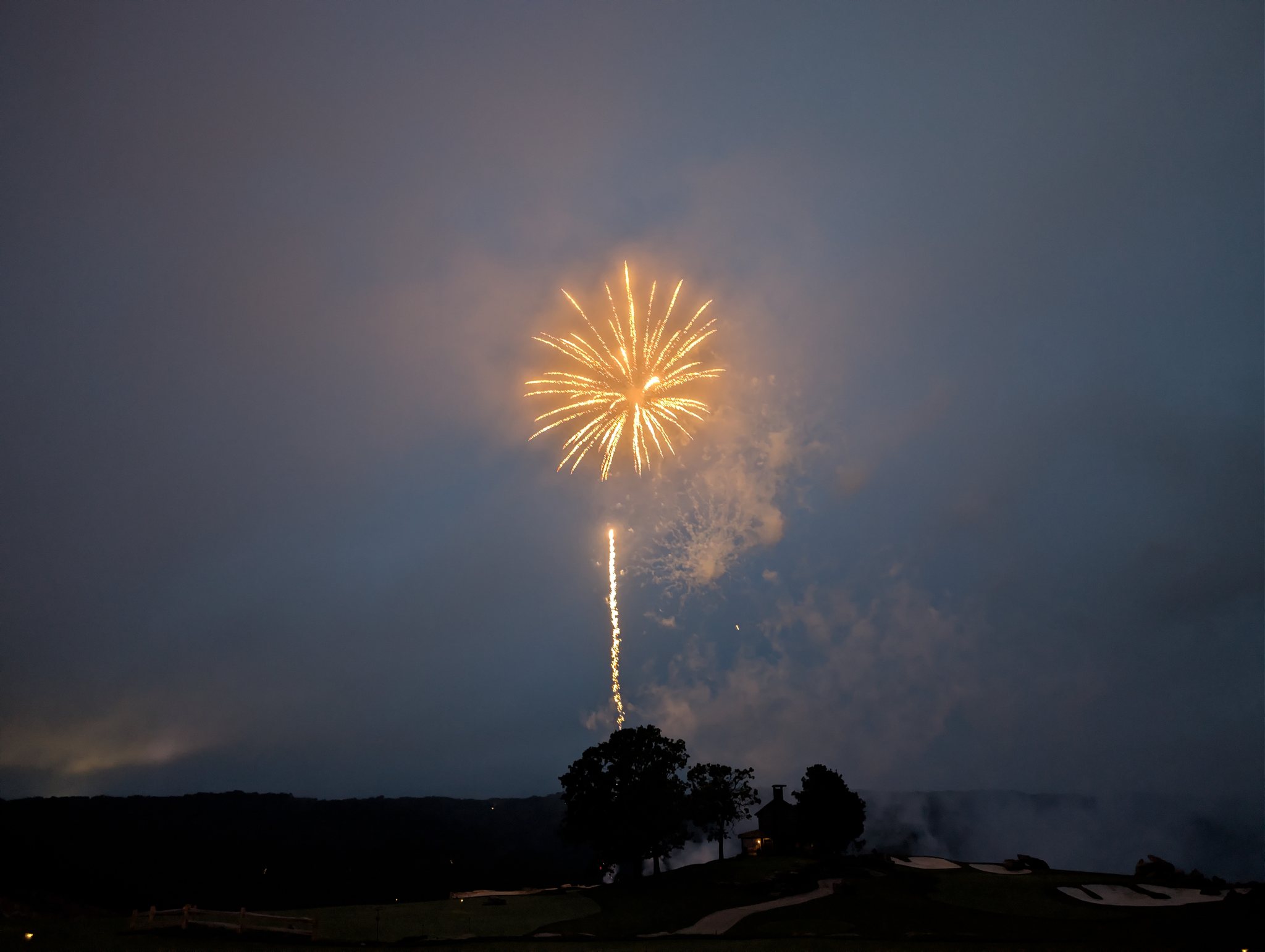 Golden firework bursting over the Ozarks hills at Top of the Rock near Branson, Missouri