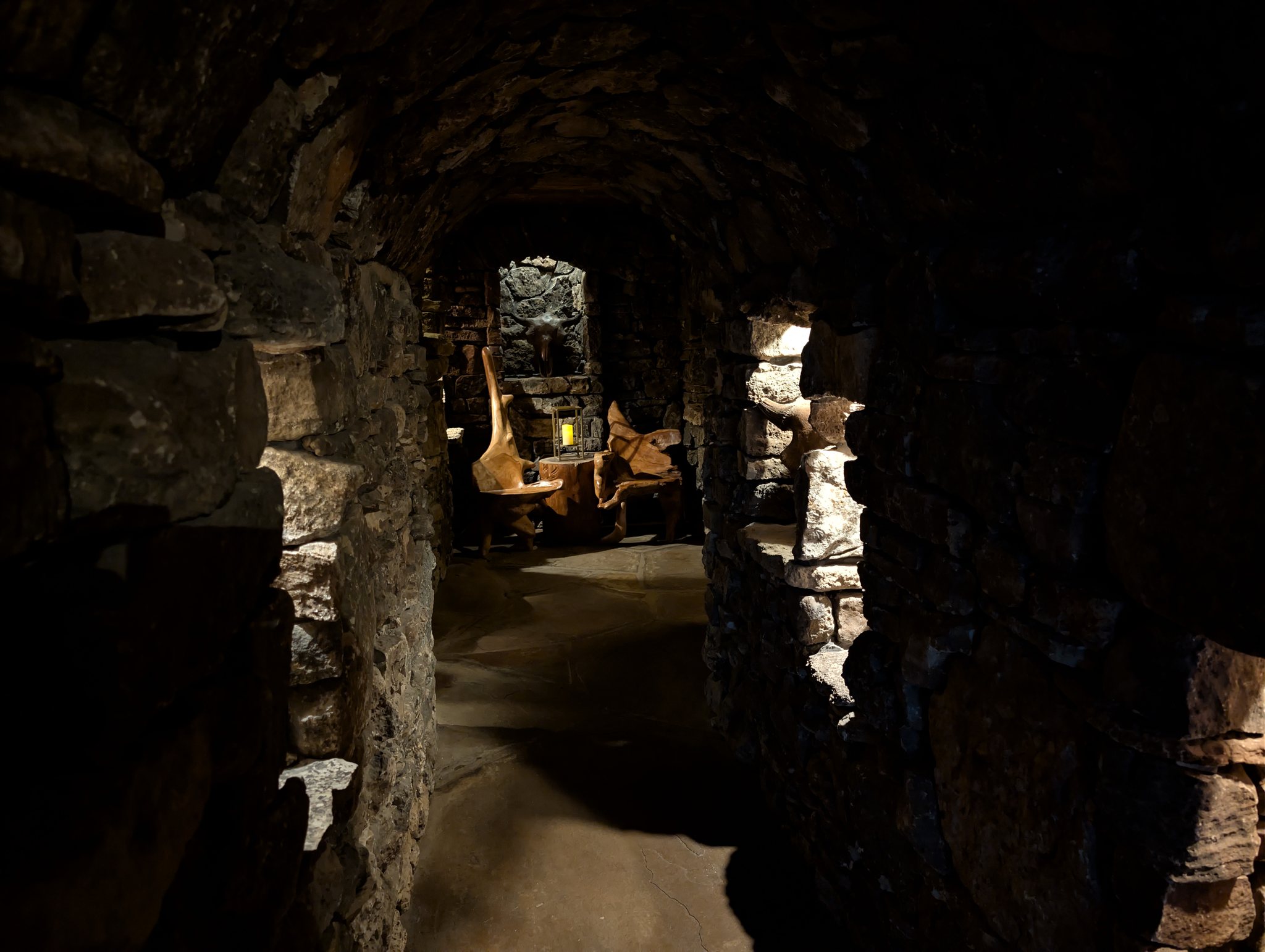 Candlelit stone dining nook with rustic wood chairs at the Top of the Rock restaurant near Branson, Missouri