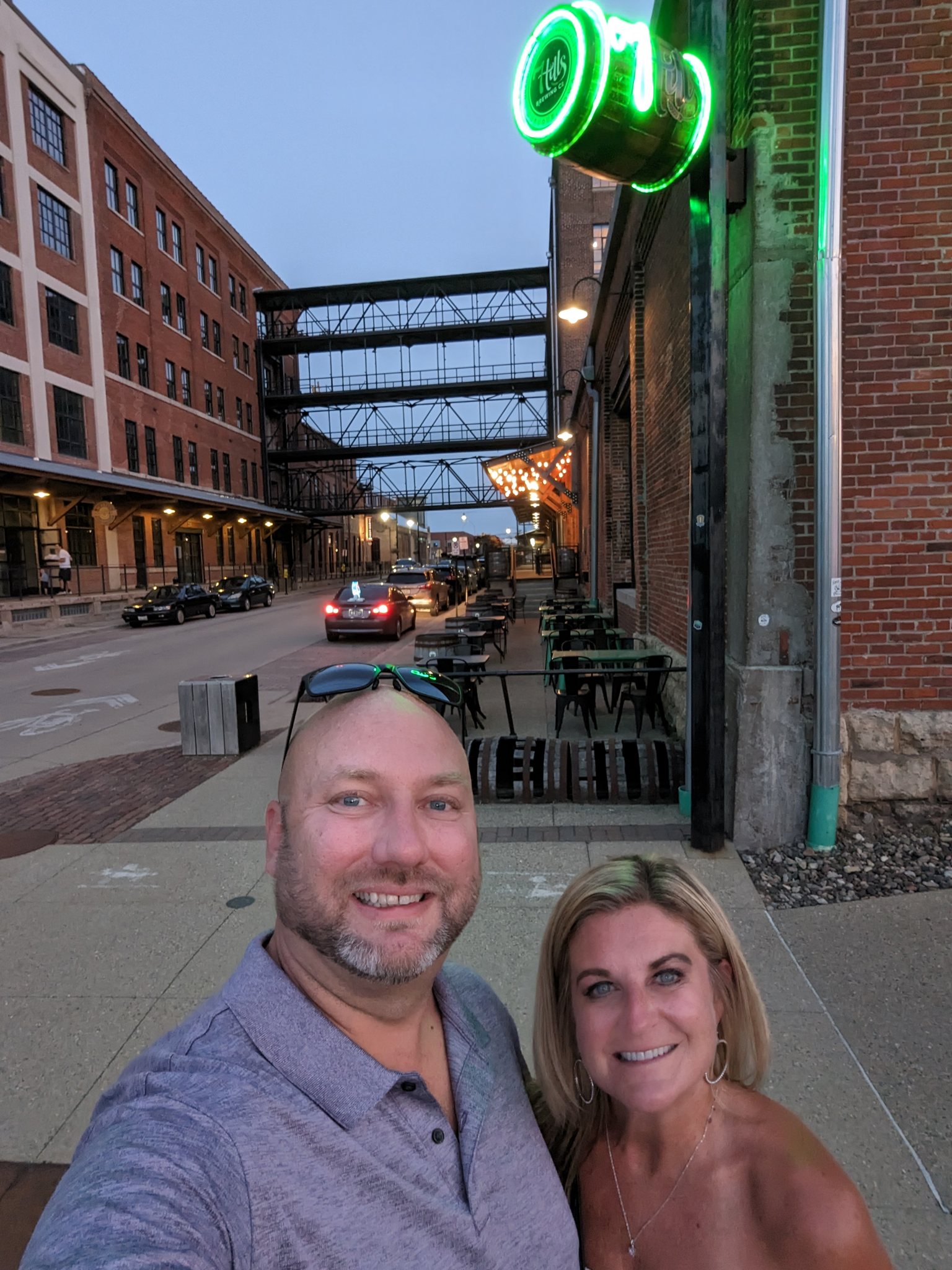 Couple selfie under the neon sign at 7 Hills Brewing Co in Dubuque Iowa
