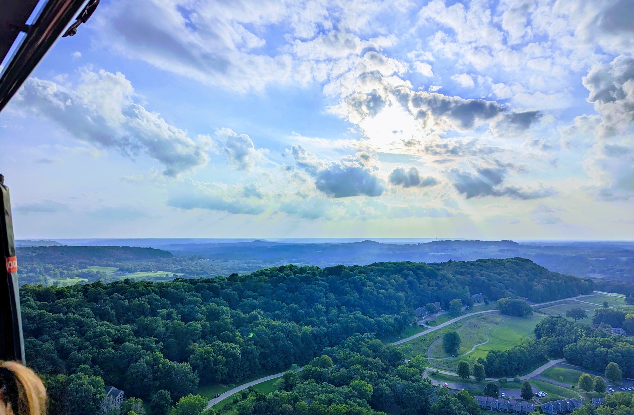 Aerial view of forested hills near Galena Illinois from a hot air balloon with sunbeams