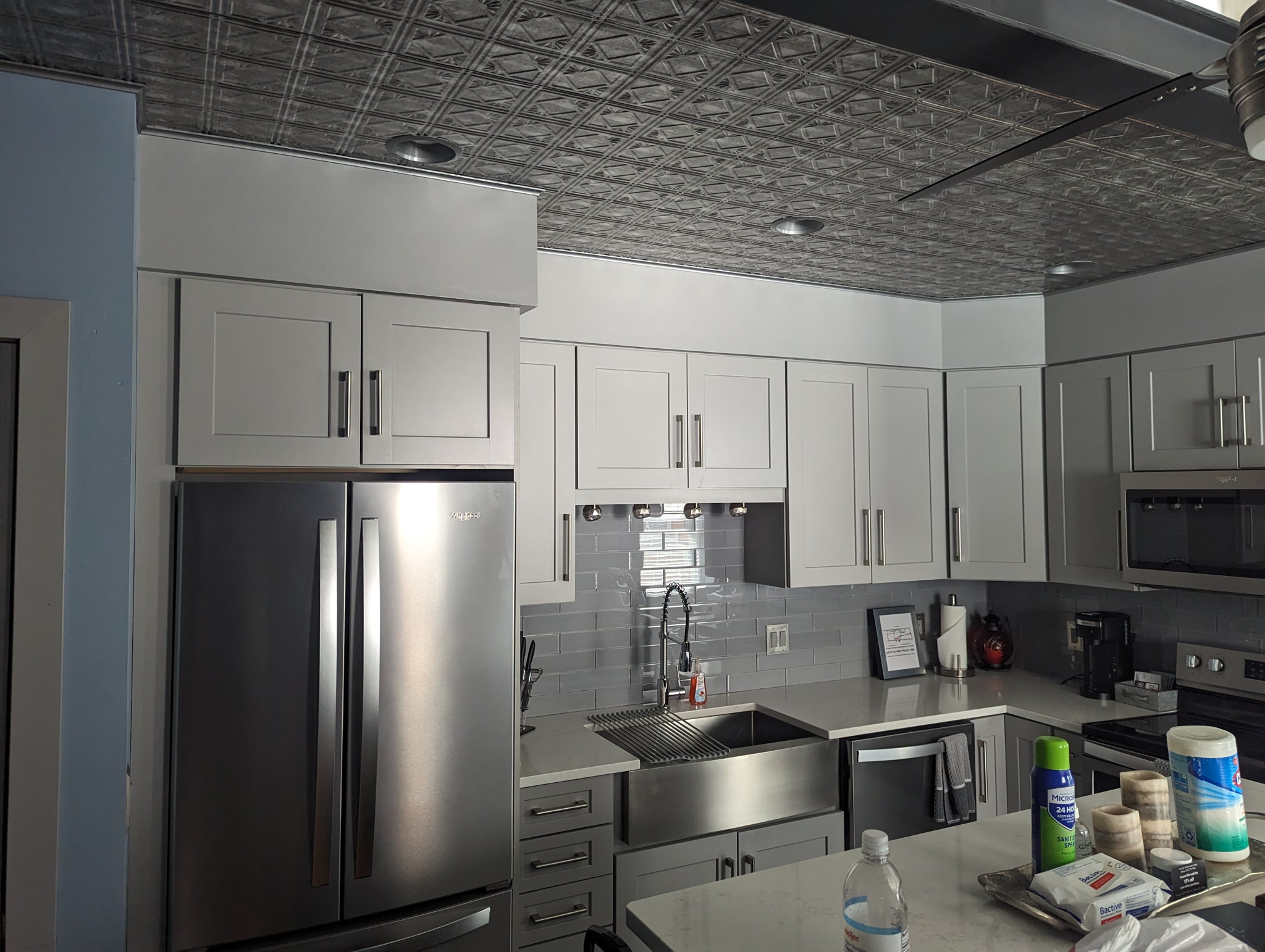 Kitchen with tin ceiling and fridge at Suite Victory Airbnb in Galena Illinois
