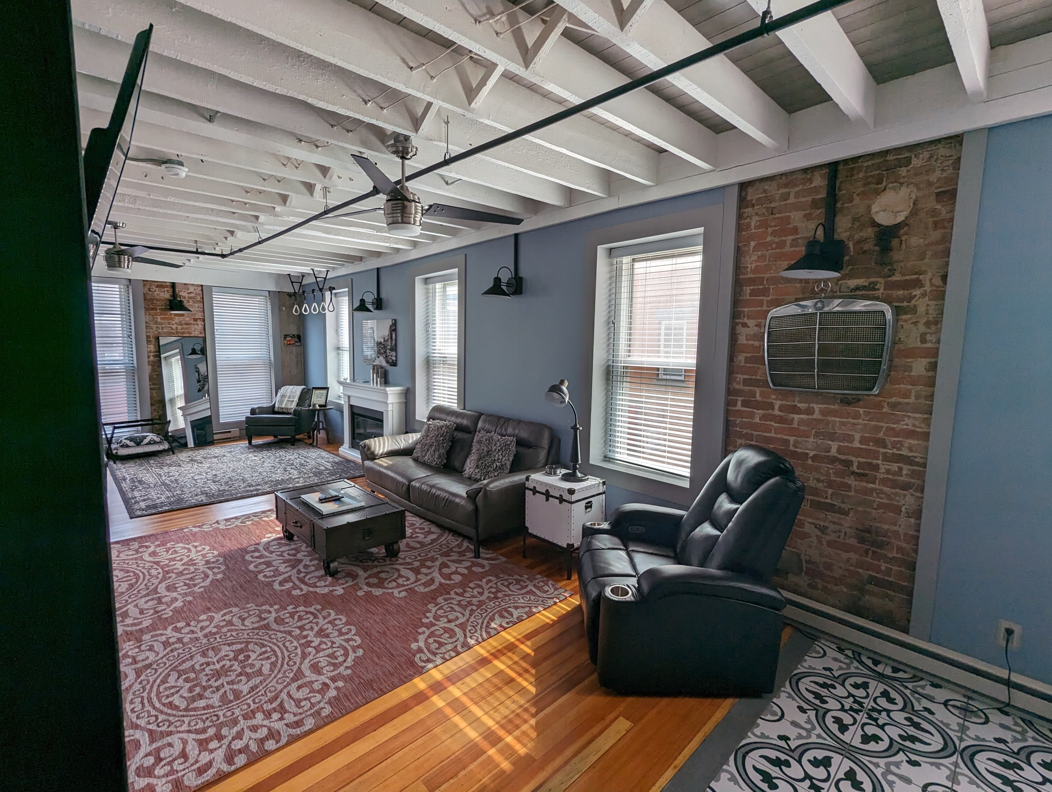 Living room with exposed brick at Suite Victory Airbnb in Galena Illinois