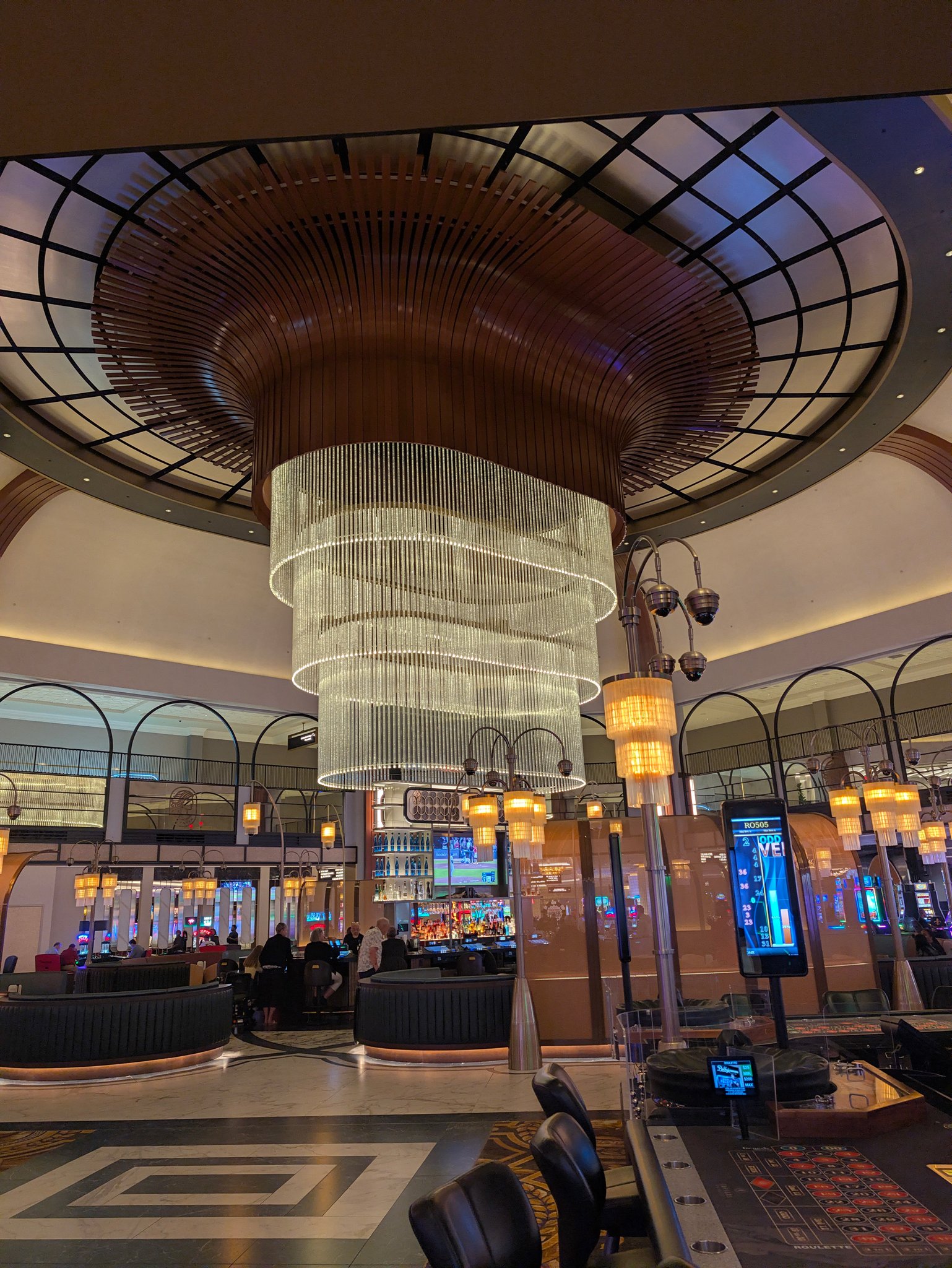 Tiered crystal chandelier hanging in the domed atrium at Caesars New Orleans