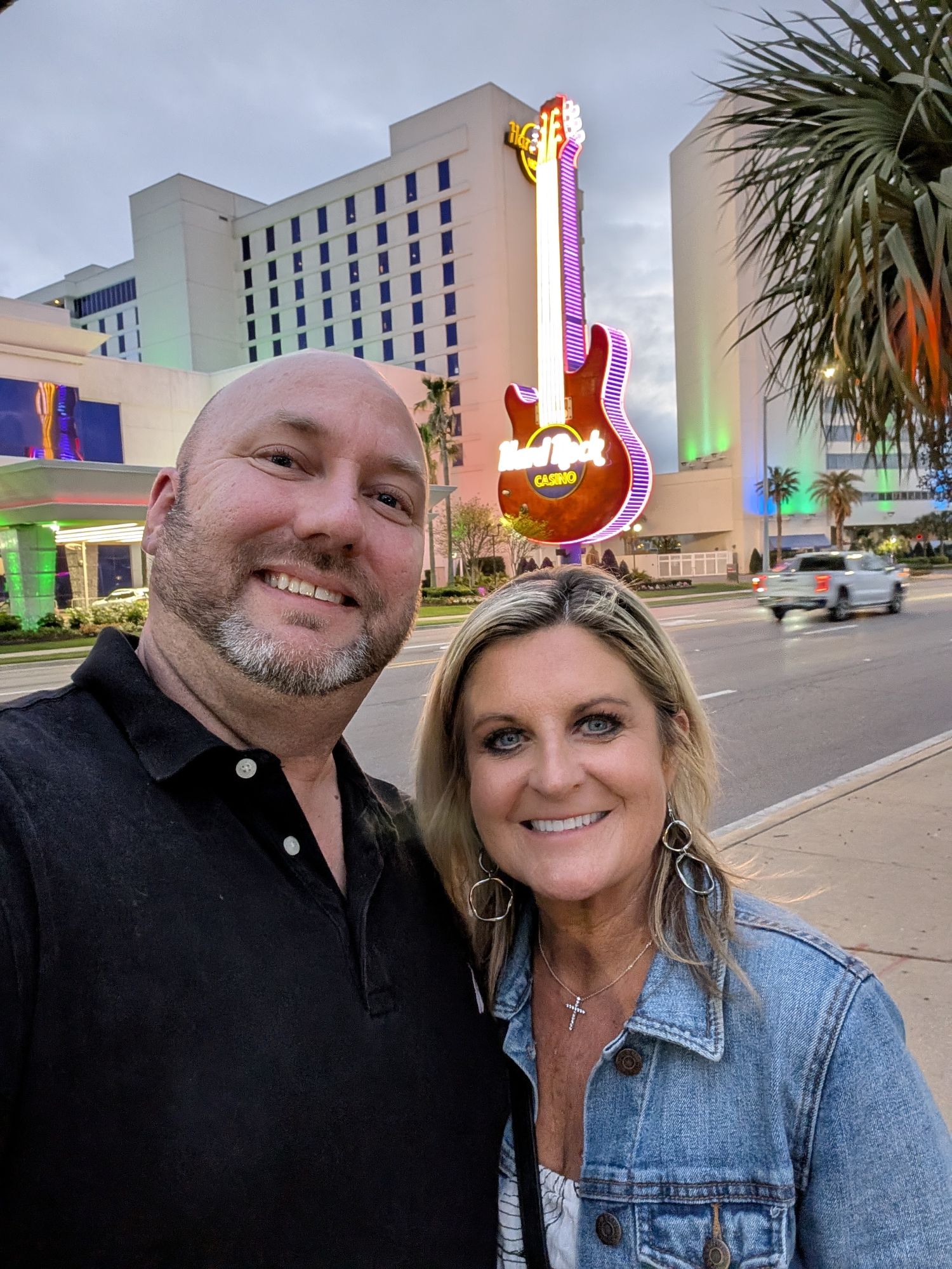 Kelli and me at dusk in front of the neon Hard Rock guitar sign in Biloxi