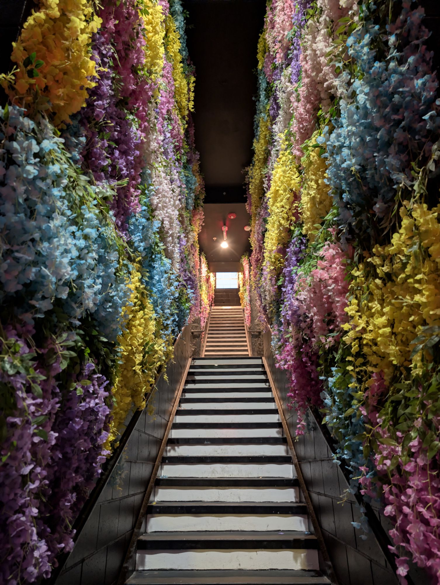 Flower-covered staircase leading up to The Mirror Bar in Ocean Springs
